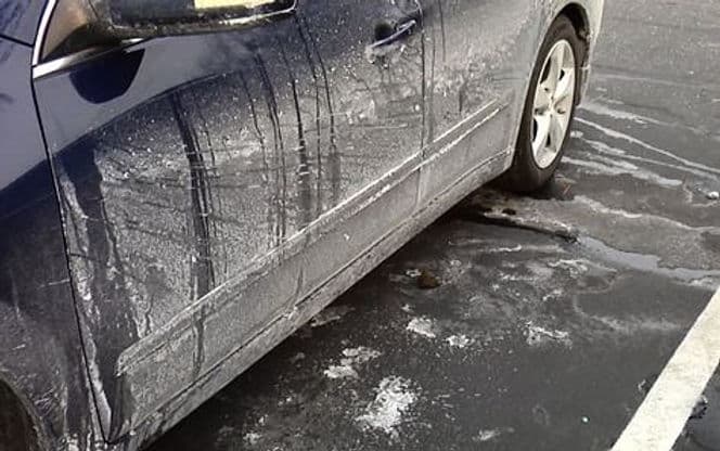 Close-up of salt/chemical buildup on vehicle undercarriage or wheel wells